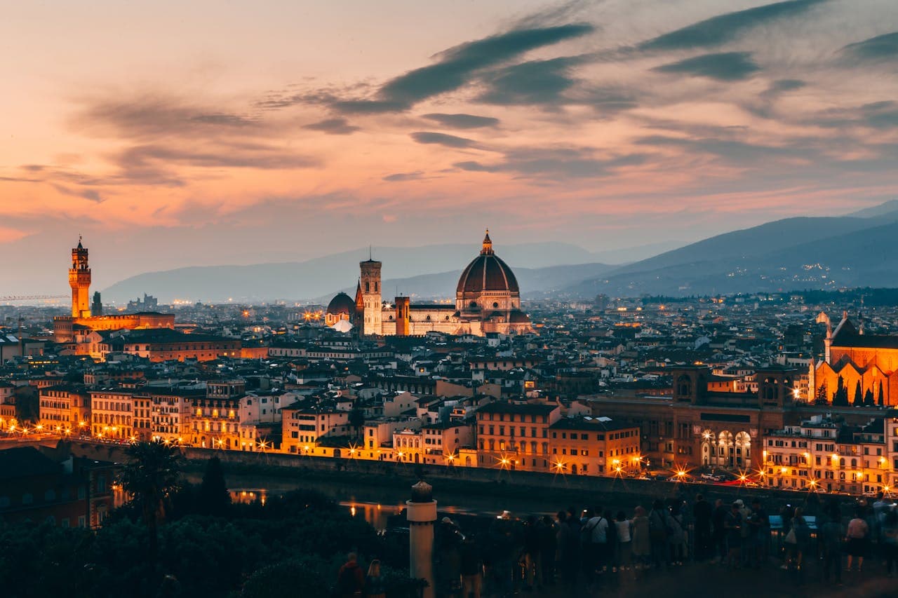 Florence cityscape at dusk with Brunelleschi's Dome and Palazzo Vecchio illuminated, perfect setting for private tours in Florence.